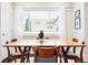 Sunlit dining room featuring a wooden table, stylish chairs, and sheer curtains at 1484 Cherry St, Denver, CO 80220