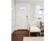 Bright entryway with hardwood floors, showcasing a stylish door and a cozy seating area at 1484 Cherry St, Denver, CO 80220