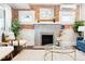 Bright living room with exposed brick fireplace, comfortable seating, and stylish decor at 1484 Cherry St, Denver, CO 80220