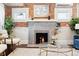 Cozy living room featuring a stylish fireplace with brick surround and modern decor at 1484 Cherry St, Denver, CO 80220