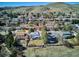 Scenic aerial view of a neighborhood nestled near a mountain, showcasing a variety of home styles and landscaping at 14259 W Virginia Dr, Lakewood, CO 80228