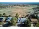 Aerial view showcases the home surrounded by mature trees and a rolling hillside at 14259 W Virginia Dr, Lakewood, CO 80228