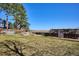 Large backyard featuring a spacious lawn, garden area, a pergola, wooden fencing, and scenic field views at 14259 W Virginia Dr, Lakewood, CO 80228