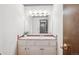 Bright powder room features charming retro tiling, vanity with storage, and brass fixtures at 14259 W Virginia Dr, Lakewood, CO 80228