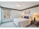 Well-lit bedroom with a comfortable queen size bed, matching lamps, neutral color palette and a view from the window at 14259 W Virginia Dr, Lakewood, CO 80228