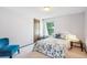 Cozy bedroom with a patterned bedspread and a comfortable blue chair at 14259 W Virginia Dr, Lakewood, CO 80228
