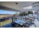 Beautiful covered deck area with multiple tables and seating overlooking a scenic view at 14259 W Virginia Dr, Lakewood, CO 80228