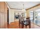 Elegant dining room with wood floors, a chandelier, and access to an outdoor deck at 14259 W Virginia Dr, Lakewood, CO 80228