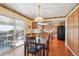 Cozy dining area featuring a view of the deck and a modern chandelier above the table at 14259 W Virginia Dr, Lakewood, CO 80228