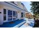 Charming home exterior featuring a covered patio and a unique door design with blue accents at 14259 W Virginia Dr, Lakewood, CO 80228