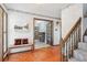 Inviting foyer with hardwood floors, a staircase, and an open doorway to another room at 14259 W Virginia Dr, Lakewood, CO 80228