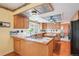 Spacious kitchen with ample cabinetry, stainless steel appliances, and a tiled countertop at 14259 W Virginia Dr, Lakewood, CO 80228