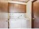 Laundry room featuring a side-by-side washer and dryer with storage cabinets above at 14259 W Virginia Dr, Lakewood, CO 80228