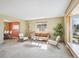 Inviting living room with neutral tones, plush carpet, and bright natural light, ideal for relaxation at 14259 W Virginia Dr, Lakewood, CO 80228