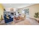 Comfortable living room with a stone fireplace, plush seating, and a large window at 14259 W Virginia Dr, Lakewood, CO 80228