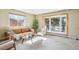 Comfortable living room with plush carpet, neutral tones, and large windows to let in light at 14259 W Virginia Dr, Lakewood, CO 80228