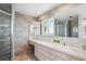 Bathroom with a walk-in shower, large vanity, and natural light at 14259 W Virginia Dr, Lakewood, CO 80228