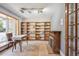 Home office space with a decorative fireplace, built-in shelving, and plenty of natural light at 14259 W Virginia Dr, Lakewood, CO 80228