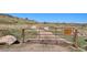 Trail entrance with gate and posted signs, with path leading up a hill at 14259 W Virginia Dr, Lakewood, CO 80228