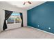 Bedroom featuring neutral carpet, a statement wall, and lots of natural light at 9633 E 5Th Ave # 10208, Denver, CO 80230