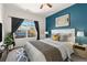 Cozy bedroom featuring a queen-size bed, stylish decor, and a large window with neighborhood views at 9633 E 5Th Ave # 10208, Denver, CO 80230