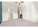 Bright bedroom with neutral carpet, ceiling fan, and white trim, featuring built-in shelves at 9633 E 5Th Ave # 10208, Denver, CO 80230