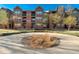 Attractive three-story red brick building with black balconies and a well-manicured center circle in the entry at 9633 E 5Th Ave # 10208, Denver, CO 80230