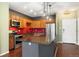 Stylish kitchen featuring stainless steel appliances, wood cabinetry and a functional island with dark countertops at 9633 E 5Th Ave # 10208, Denver, CO 80230