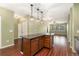 Open concept kitchen and living area with hardwood floors, an island, and lots of natural light at 9633 E 5Th Ave # 10208, Denver, CO 80230