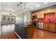 Modern kitchen with stainless steel appliances, an island with dark countertops and hardwood flooring at 9633 E 5Th Ave # 10208, Denver, CO 80230