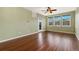 Bright living room with hardwood floors, a ceiling fan, and natural light from the large window at 9633 E 5Th Ave # 10208, Denver, CO 80230