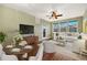 Bright and airy living room with hardwood floors, a ceiling fan, and large windows that let in plenty of natural light at 9633 E 5Th Ave # 10208, Denver, CO 80230