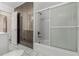 Bathroom featuring large mirrored closet doors, a tub with shower, and white tiled floors at 3334 W Grand Ave, Englewood, CO 80110