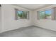 Carpeted bedroom featuring two large windows, white walls, and baseboard trim at 3334 W Grand Ave, Englewood, CO 80110