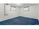 Bedroom with blue carpet, white walls, and two windows with white curtains at 3334 W Grand Ave, Englewood, CO 80110