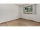 Bedroom featuring hard wood flooring, baseboard trim, and one window with natural lighting at 3334 W Grand Ave, Englewood, CO 80110