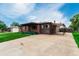 Charming single-story home featuring a brick facade, covered porch, and a convenient carport at 3334 W Grand Ave, Englewood, CO 80110