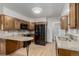 The kitchen has wood cabinets, granite countertops, backsplash, and stainless-steel appliances at 3334 W Grand Ave, Englewood, CO 80110