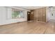 Bright, open living room with beautiful hardwood floors, and a large window at 3334 W Grand Ave, Englewood, CO 80110