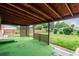 Covered outdoor patio area with artificial turf and lattice accent to backyard at 3334 W Grand Ave, Englewood, CO 80110