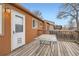 Back deck featuring wood floor, a white door, and a glass table to sit and relax outside at 3937 S Truckee St, Aurora, CO 80013