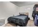 Bedroom with carpet, a window, a bed with dark blue bedding, and wire shelving for additional storage at 3937 S Truckee St, Aurora, CO 80013