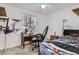 Bright bedroom with a ceiling fan and a large window, desk, and game chair at 3937 S Truckee St, Aurora, CO 80013