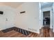 Bright entryway featuring hardwood flooring, a white door, and coat hooks on a white wall at 3937 S Truckee St, Aurora, CO 80013