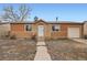 Welcoming home featuring a well-manicured lawn, neutral-colored siding, and an attached garage at 3937 S Truckee St, Aurora, CO 80013