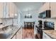 Well-lit kitchen offering white cabinets, updated countertops, and an adjacent dining space at 3937 S Truckee St, Aurora, CO 80013
