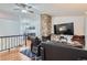 Comfortable living room showcasing a stone fireplace, hardwood floors and adjoining dining area at 3937 S Truckee St, Aurora, CO 80013