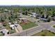Aerial view of residential neighborhood showcasing home's location near mature trees and city views at 2401 W Jewell Ave, Denver, CO 80219