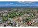An aerial view of a charming neighborhood with mature trees and a mountain backdrop at 2401 W Jewell Ave, Denver, CO 80219
