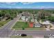 Aerial view of a charming home in a well-treed neighborhood, with mountain views, showcasing its location at 2401 W Jewell Ave, Denver, CO 80219